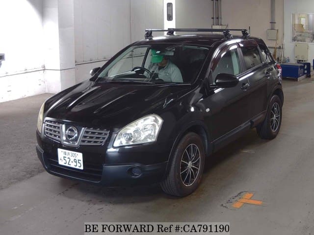A grey JDM sports car speeding down a highway at night.