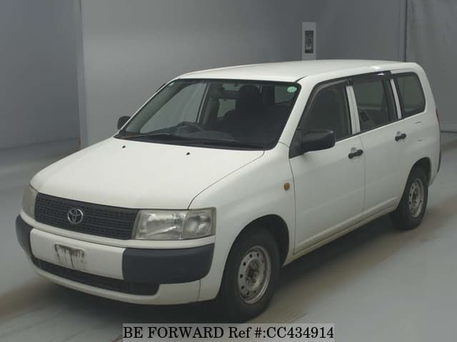 A grey JDM sports car speeding down a highway at night.