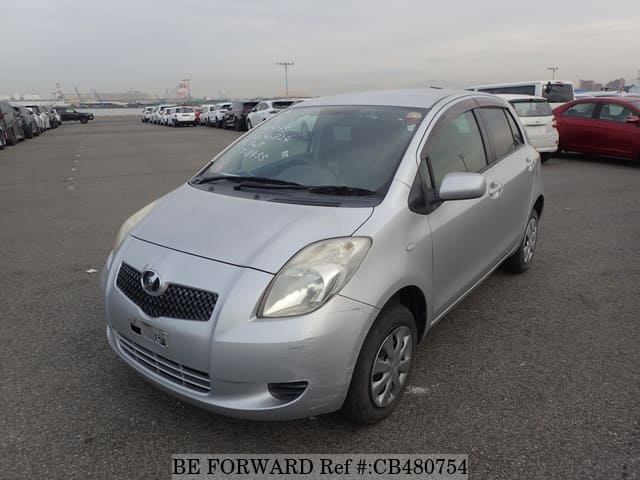 A grey JDM sports car speeding down a highway at night.