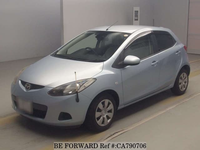 A grey JDM sports car speeding down a highway at night.