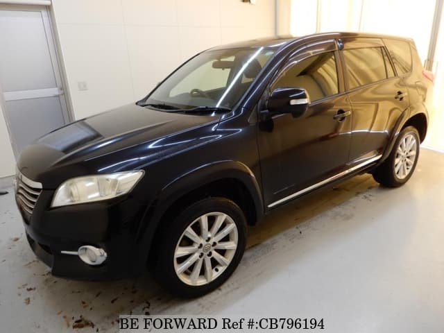 A grey JDM sports car speeding down a highway at night.