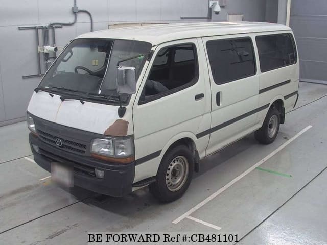 A grey JDM sports car speeding down a highway at night.
