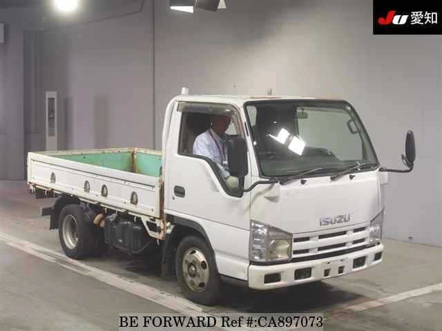 A grey JDM sports car speeding down a highway at night.