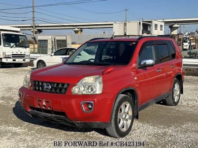 A grey JDM sports car speeding down a highway at night.
