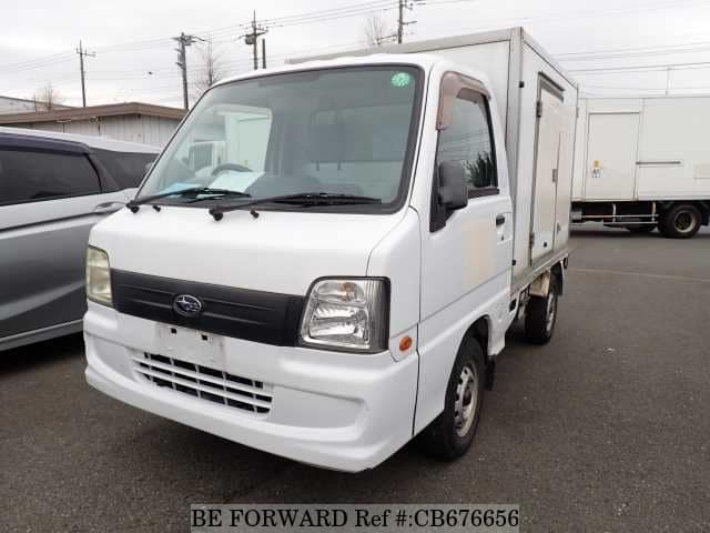 A grey JDM sports car speeding down a highway at night.