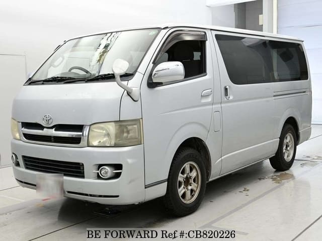 A grey JDM sports car speeding down a highway at night.