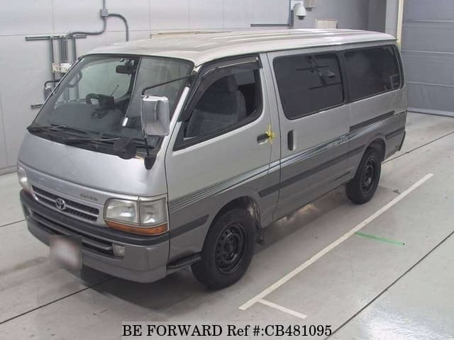 A grey JDM sports car speeding down a highway at night.