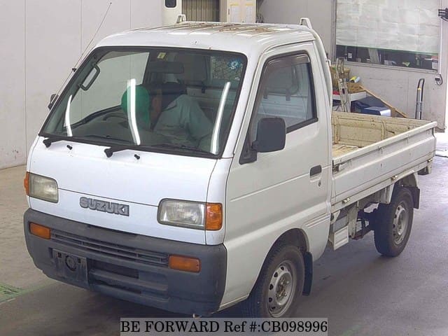 A grey JDM sports car speeding down a highway at night.