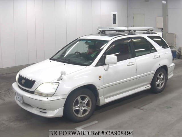 A grey JDM sports car speeding down a highway at night.