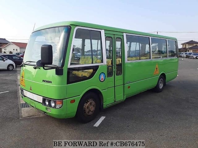 A grey JDM sports car speeding down a highway at night.