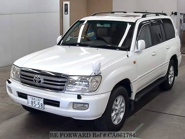A grey JDM sports car speeding down a highway at night.