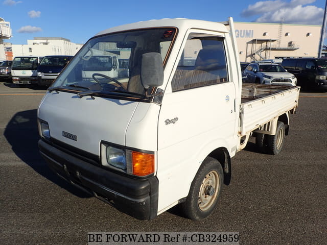 A grey JDM sports car speeding down a highway at night.