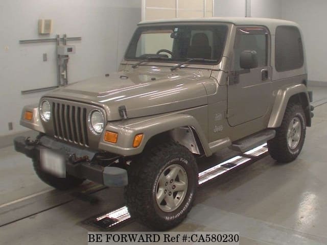 A grey JDM sports car speeding down a highway at night.
