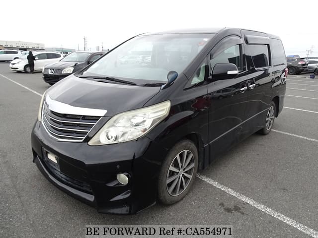 A grey JDM sports car speeding down a highway at night.