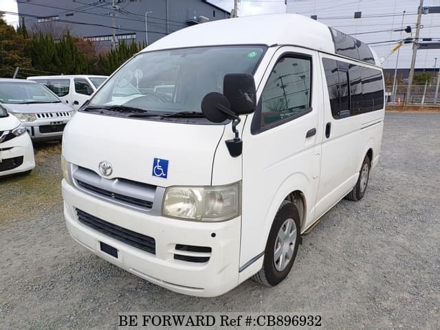 A grey JDM sports car speeding down a highway at night.