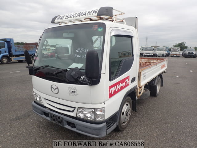 A grey JDM sports car speeding down a highway at night.