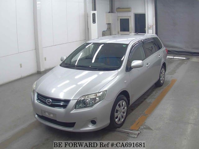 A grey JDM sports car speeding down a highway at night.