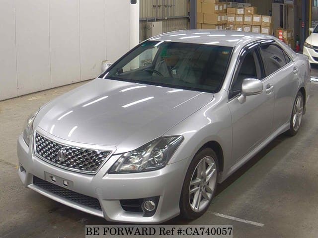 A grey JDM sports car speeding down a highway at night.