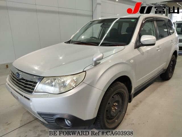 A grey JDM sports car speeding down a highway at night.