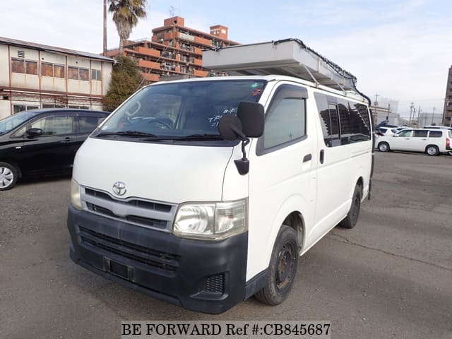 A grey JDM sports car speeding down a highway at night.