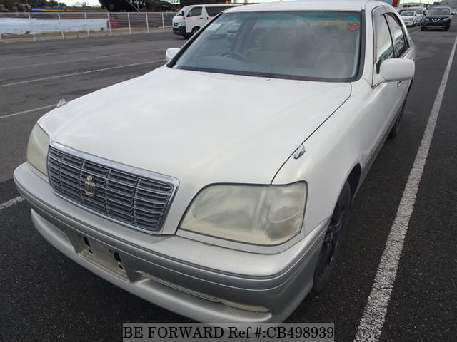 A grey JDM sports car speeding down a highway at night.