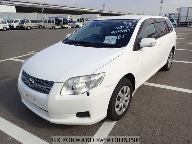 A grey JDM sports car speeding down a highway at night.