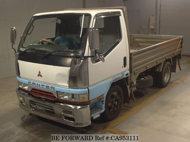 A grey JDM sports car speeding down a highway at night.