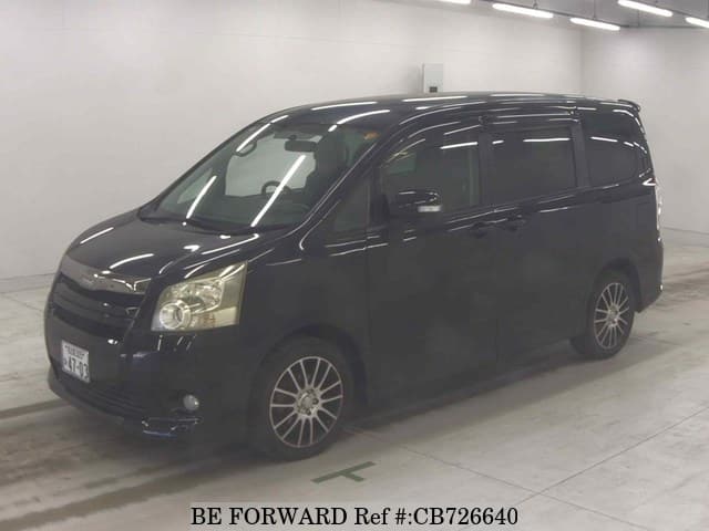 A grey JDM sports car speeding down a highway at night.