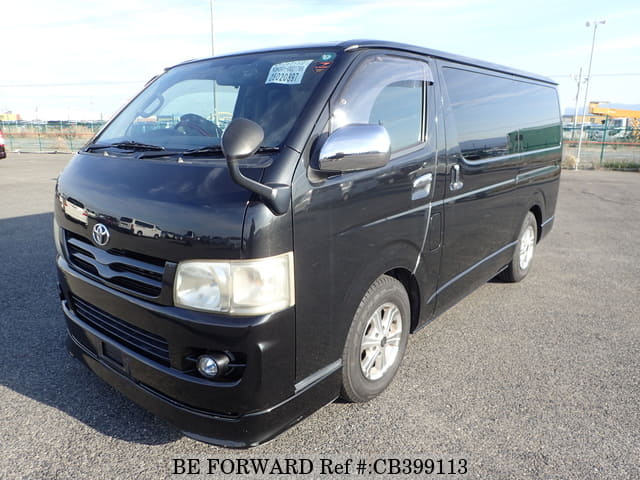 A grey JDM sports car speeding down a highway at night.