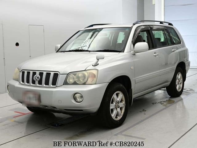 A grey JDM sports car speeding down a highway at night.
