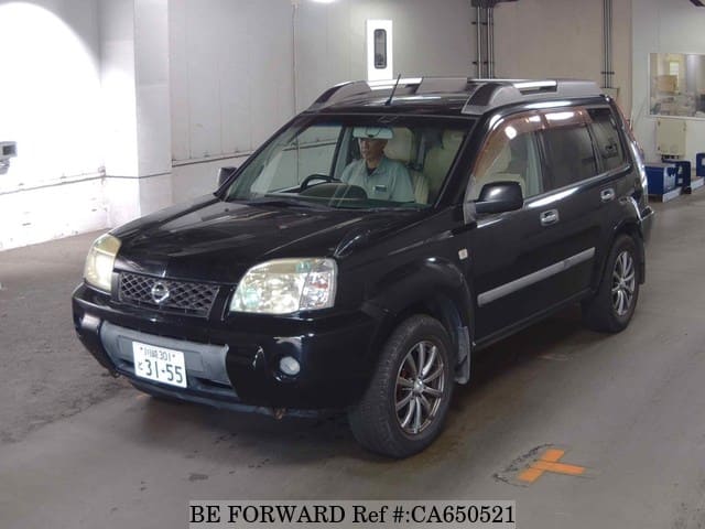 A grey JDM sports car speeding down a highway at night.