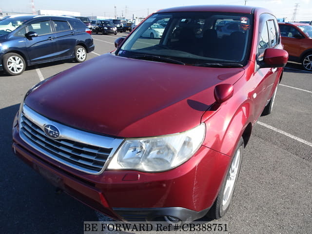 A grey JDM sports car speeding down a highway at night.