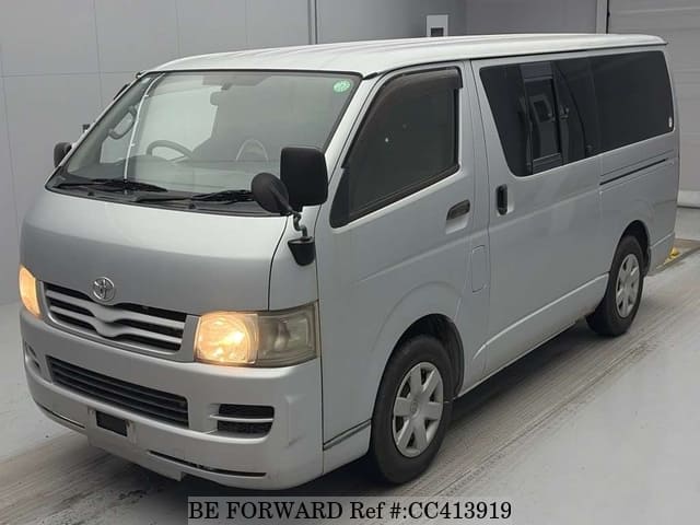 A grey JDM sports car speeding down a highway at night.