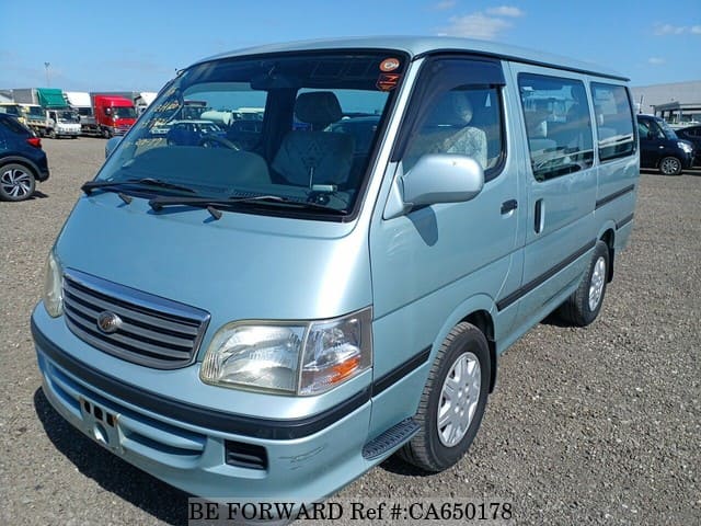 A grey JDM sports car speeding down a highway at night.