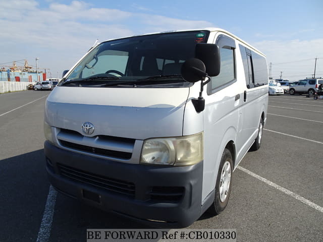 A grey JDM sports car speeding down a highway at night.
