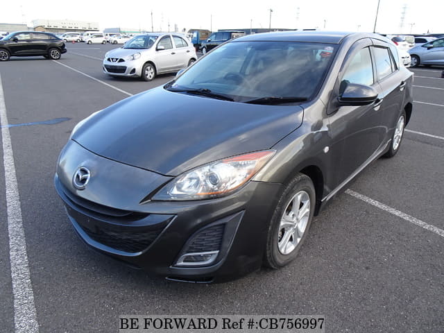 A grey JDM sports car speeding down a highway at night.
