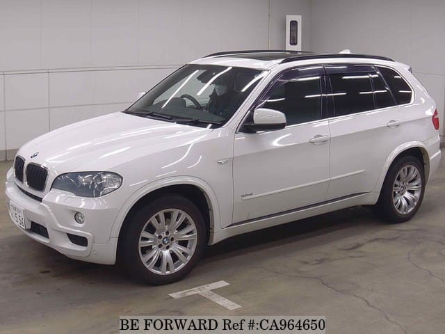 A grey JDM sports car speeding down a highway at night.