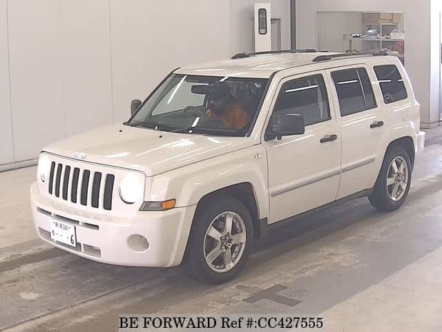 A grey JDM sports car speeding down a highway at night.