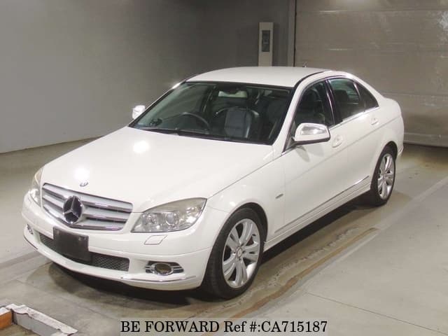 A grey JDM sports car speeding down a highway at night.