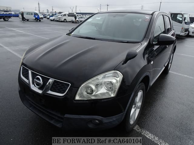 A grey JDM sports car speeding down a highway at night.