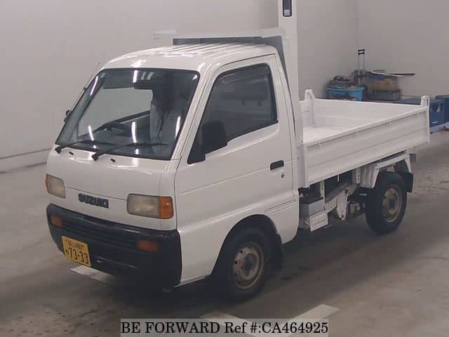 A grey JDM sports car speeding down a highway at night.