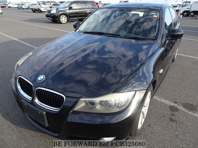 A grey JDM sports car speeding down a highway at night.