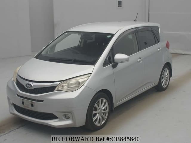 A grey JDM sports car speeding down a highway at night.