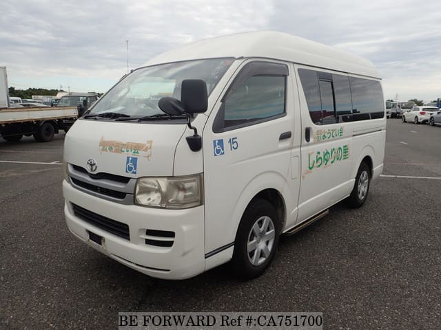 A grey JDM sports car speeding down a highway at night.