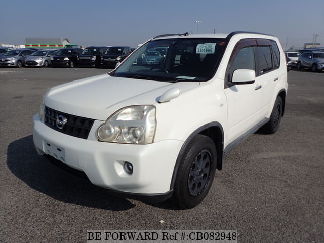 A grey JDM sports car speeding down a highway at night.