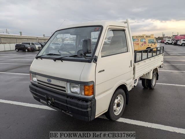 A grey JDM sports car speeding down a highway at night.