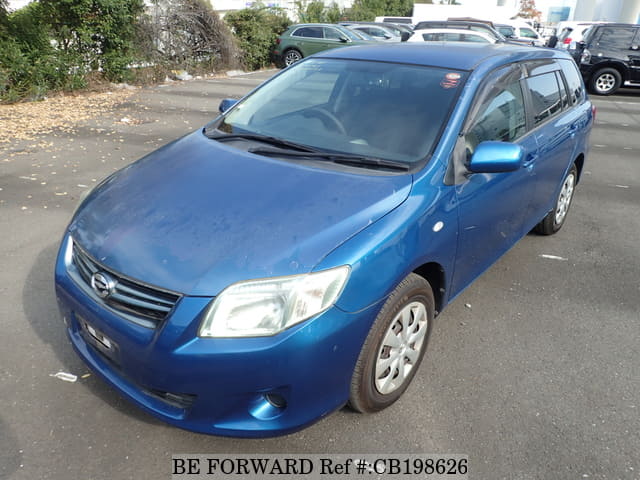 A grey JDM sports car speeding down a highway at night.