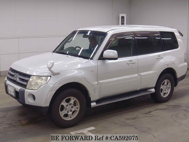 A grey JDM sports car speeding down a highway at night.