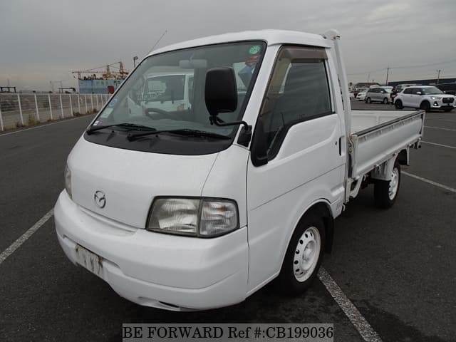 A grey JDM sports car speeding down a highway at night.