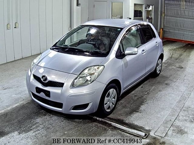 A grey JDM sports car speeding down a highway at night.